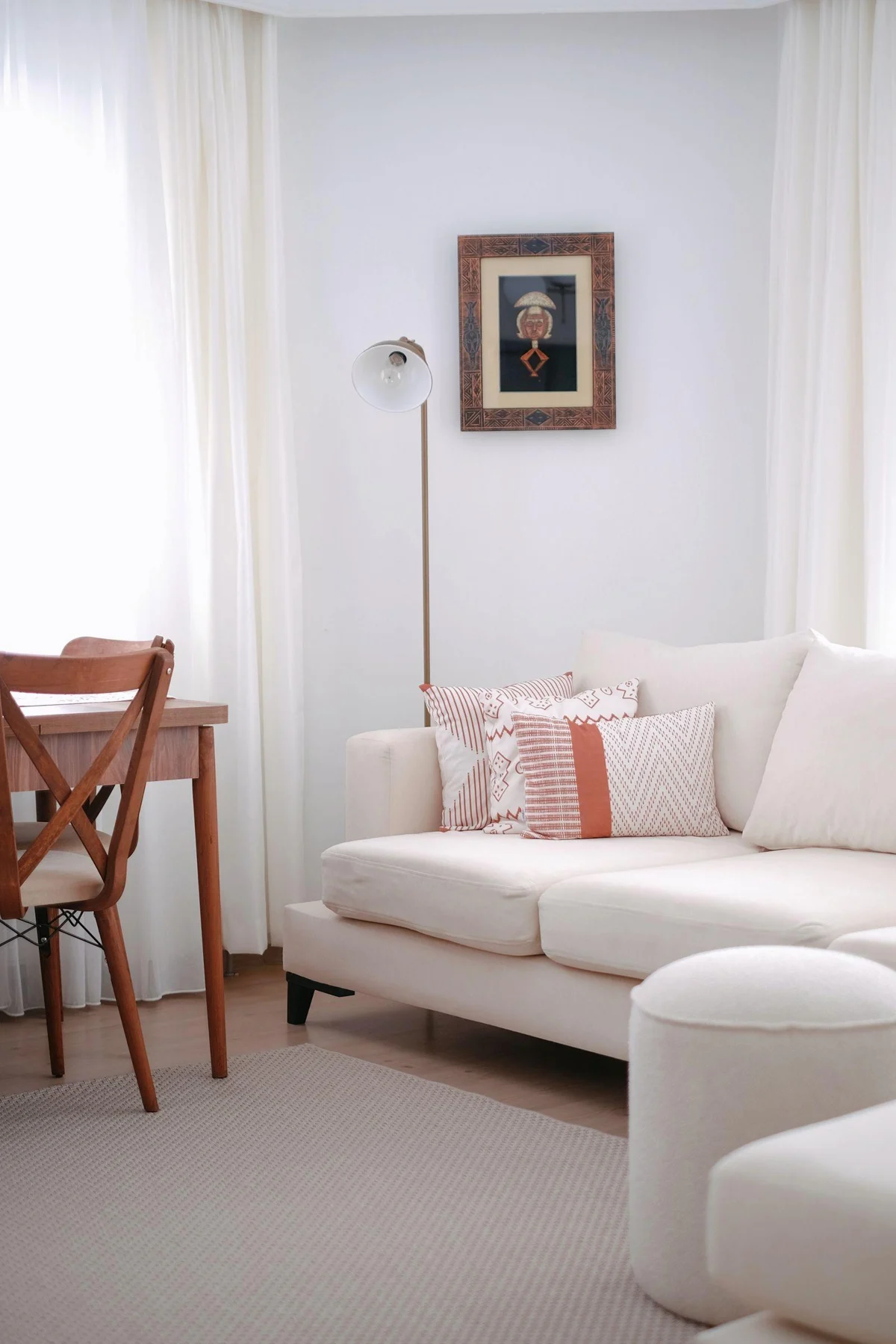 A single compact framed artwork in a bright room with white seating.