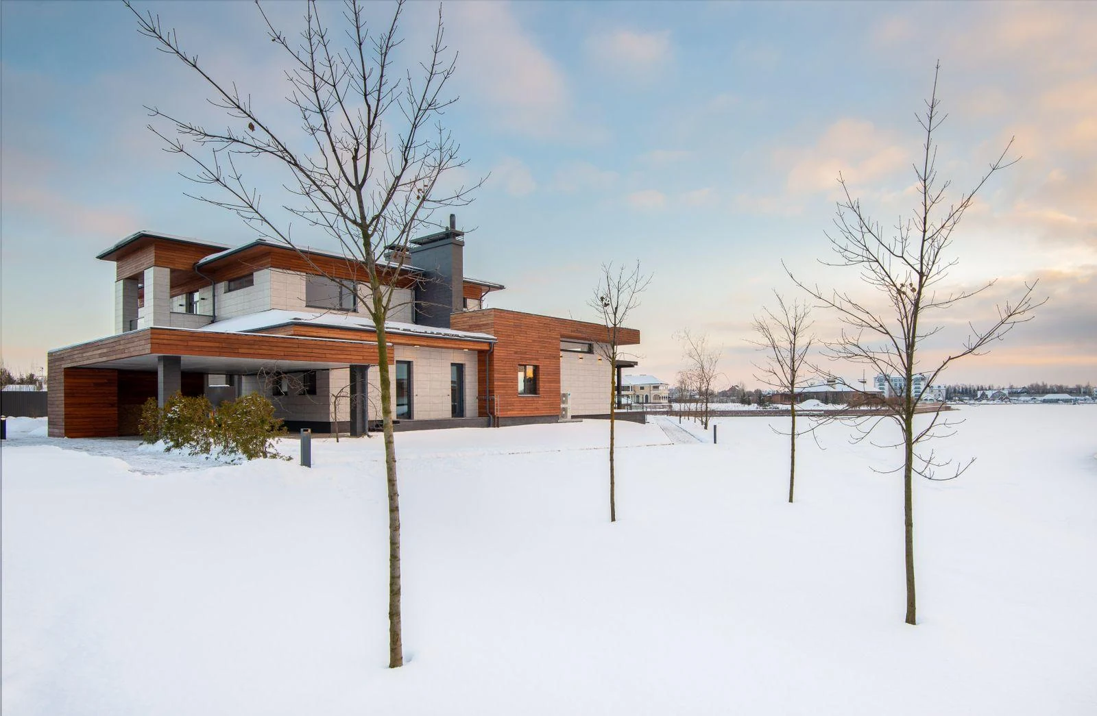 A complete modern house facade in winter, illustrating a reference photograph for a commissioned house portrait.