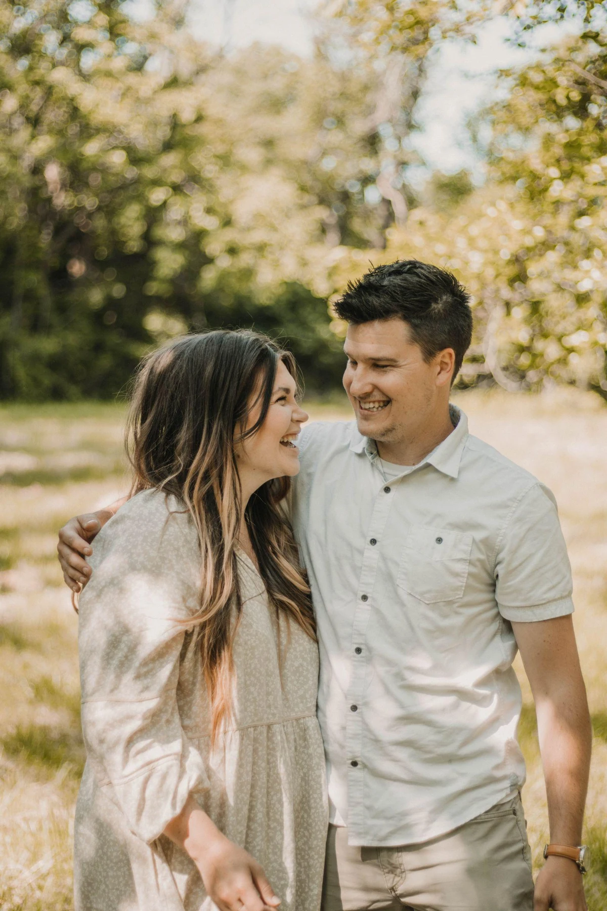 A smiling couple outdoors, illustrating a shared reference photograph for a portrait.